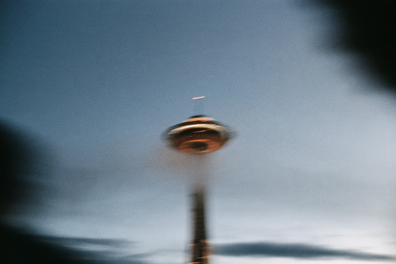 The Space Needle blurred against a dusk sky